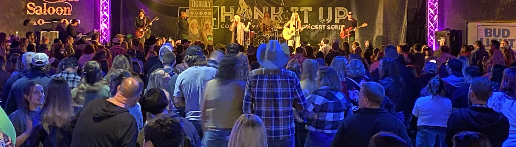 country concert with fans wearing cowboy hats Baton Rouge