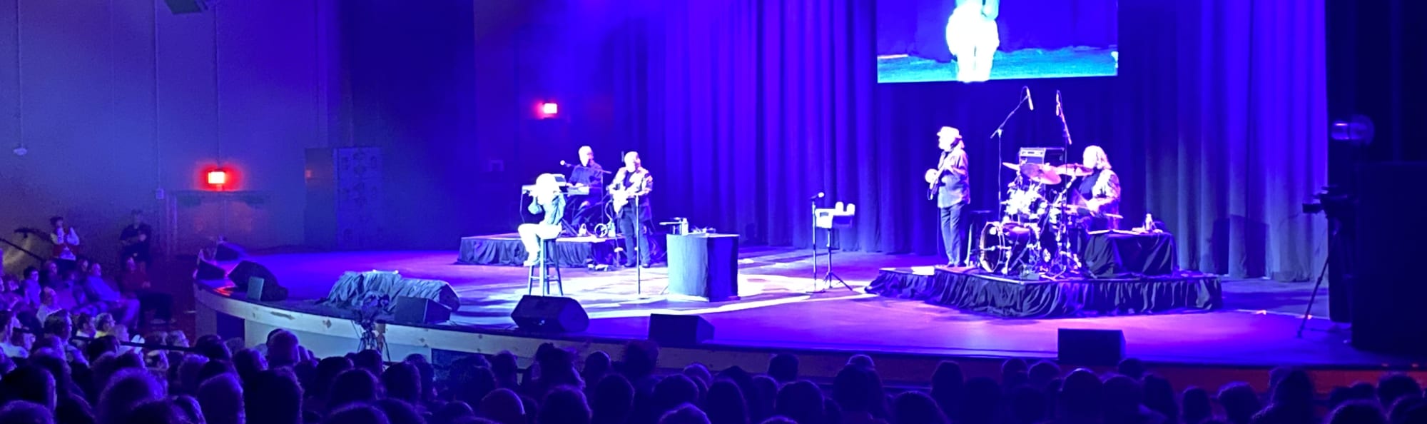 signer on stage in chair washed out by the lights Baton Rouge